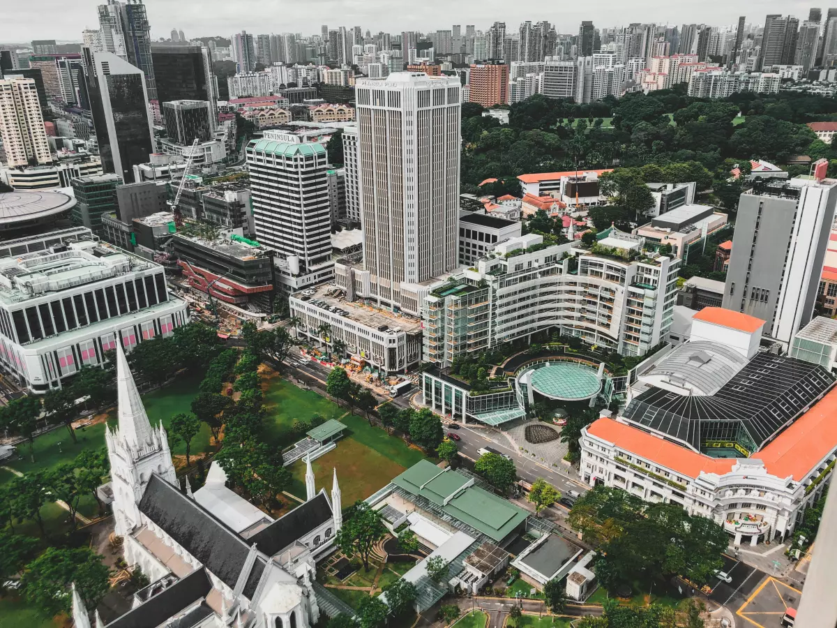 An aerial view of a city with skyscrapers and parks. 