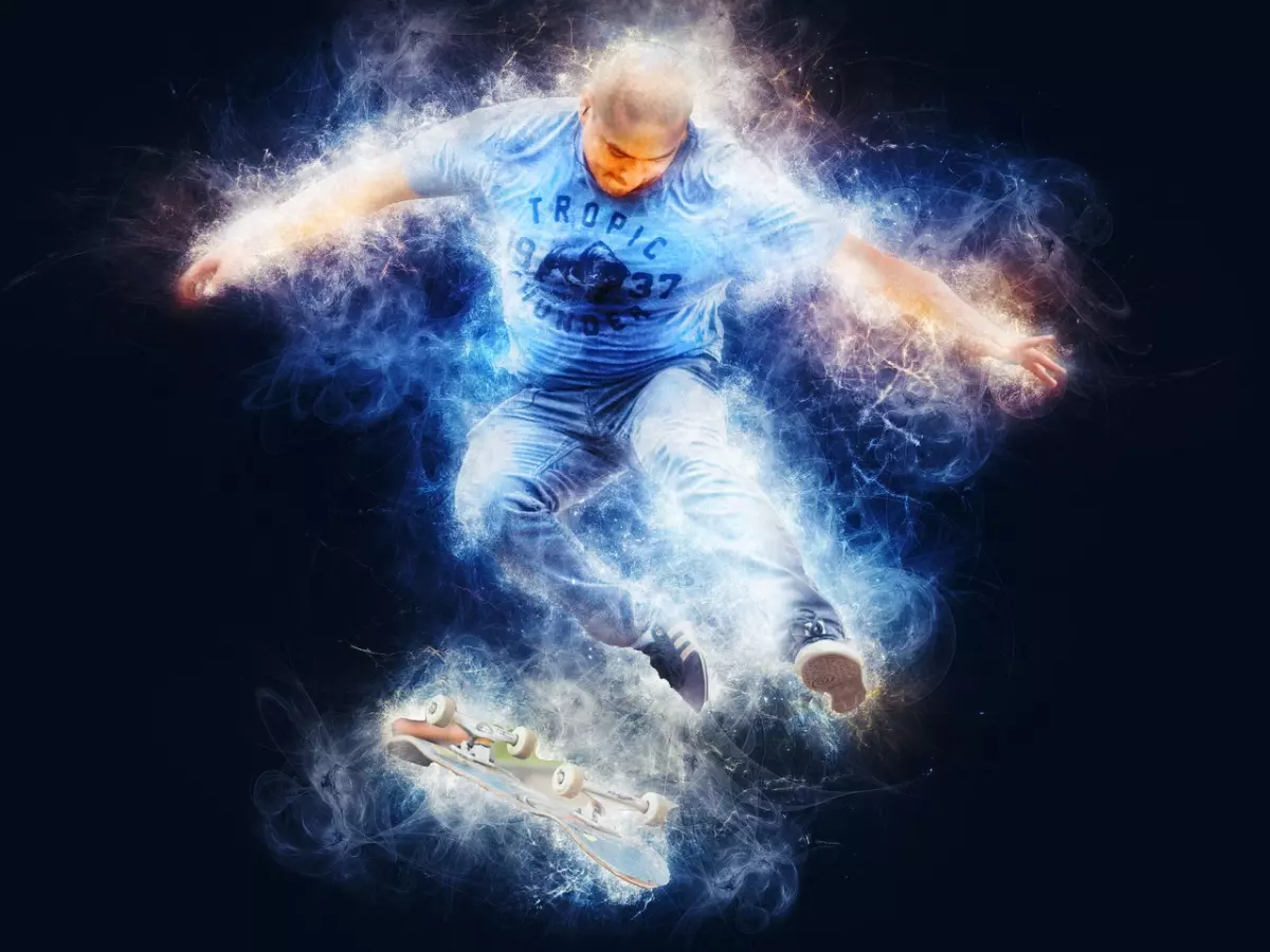 A man in a blue shirt and jeans jumps high in the air with a skateboard in a dramatic light effect. 