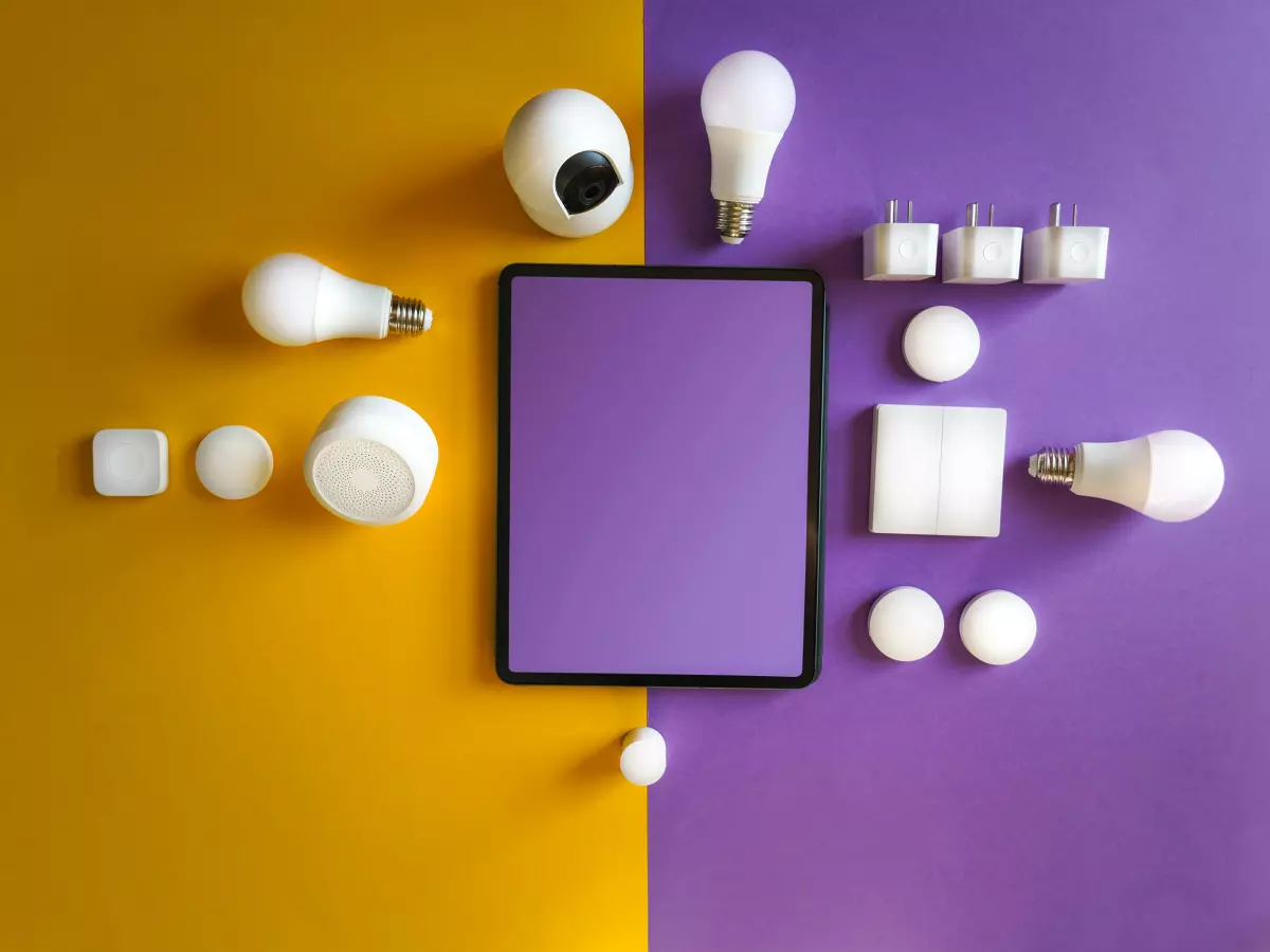 A flat lay of smart home devices on a purple and yellow background.