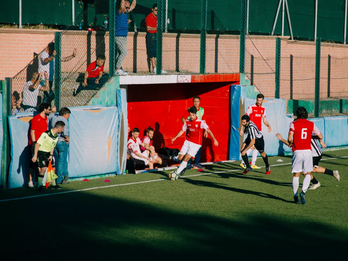 A football game in progress with players in action.