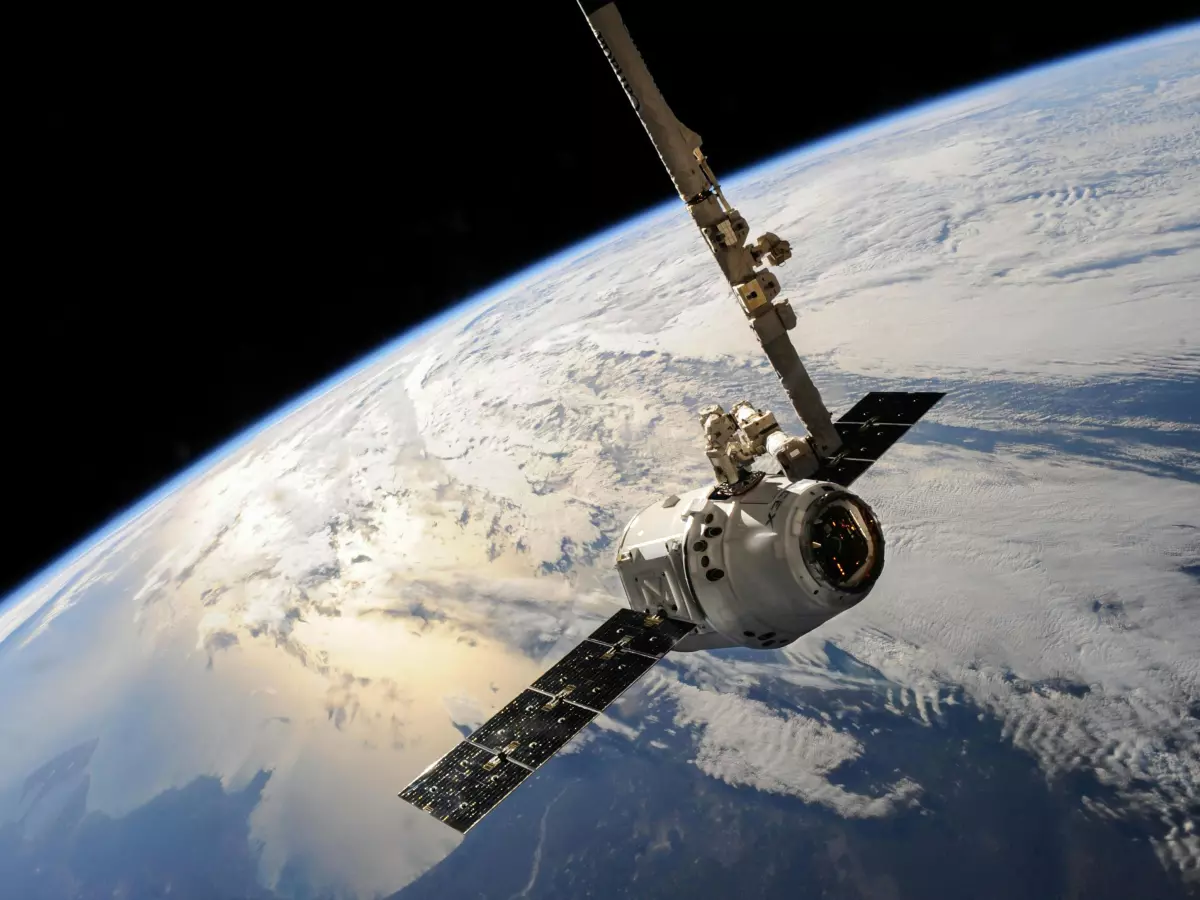 A satellite with its solar panels extended, orbiting Earth.