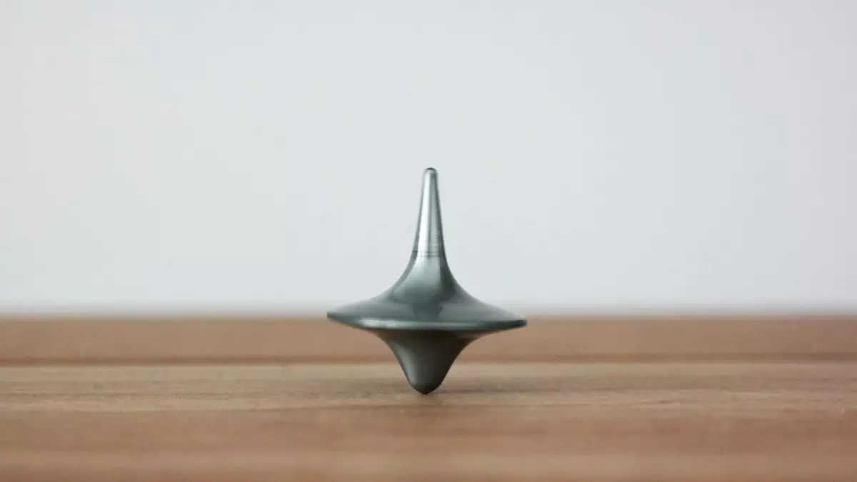 A spinning top on a wooden surface.