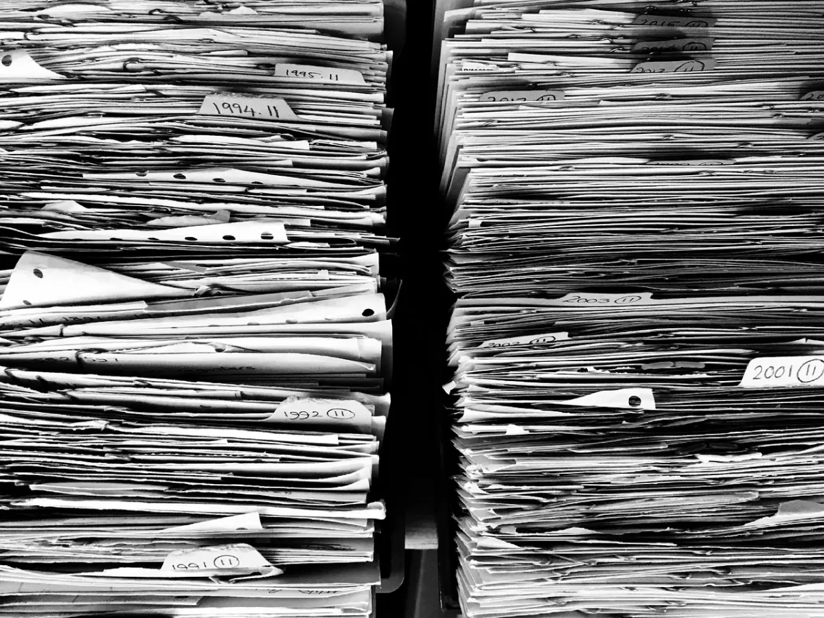 A close-up image of two stacks of papers, each labeled with years