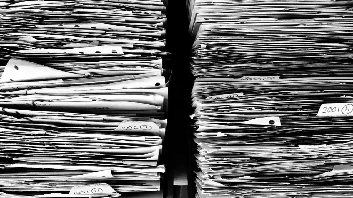 A close-up image of two stacks of papers, each labeled with years