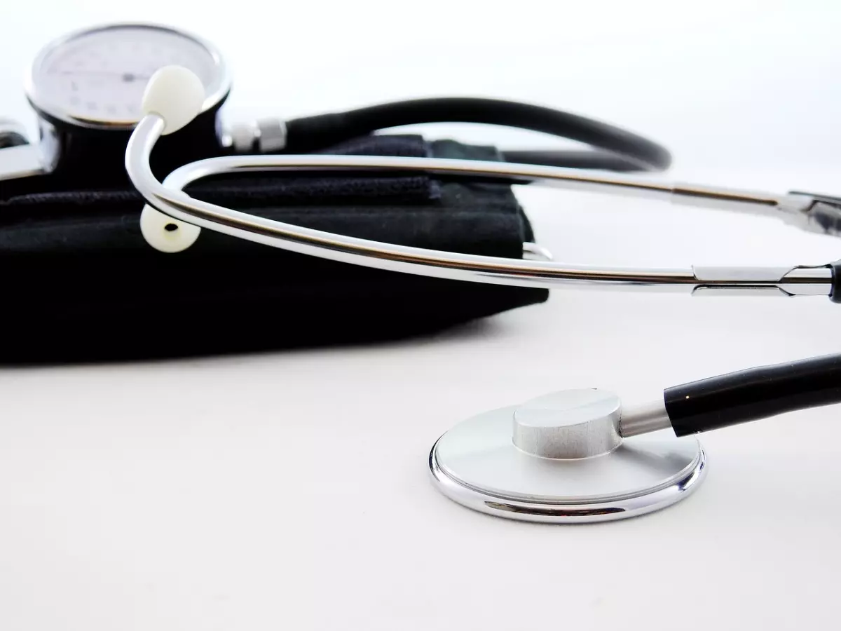 A stethoscope and a sphygmomanometer on a white surface.