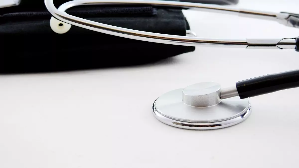 A stethoscope and a sphygmomanometer on a white surface.