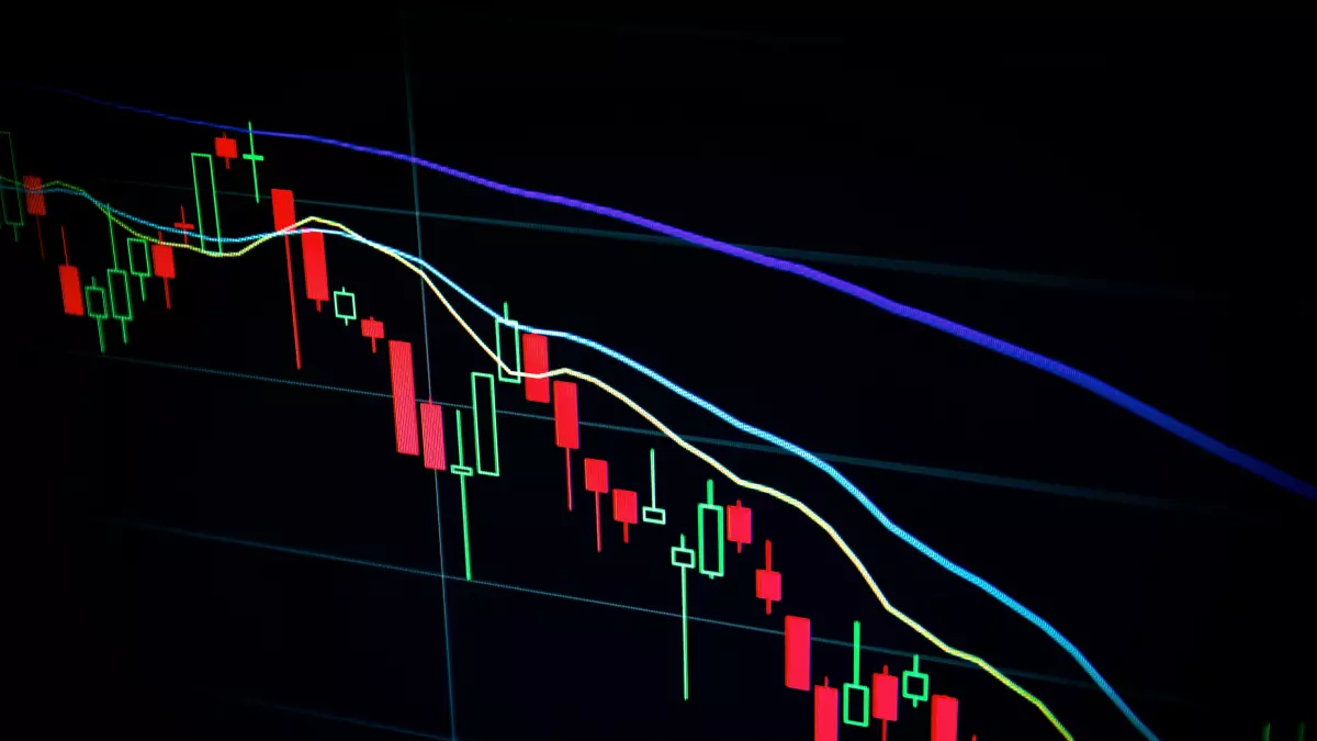 A close-up of a stock chart showing the price of a cryptocurrency, with red candlesticks representing downtrends.