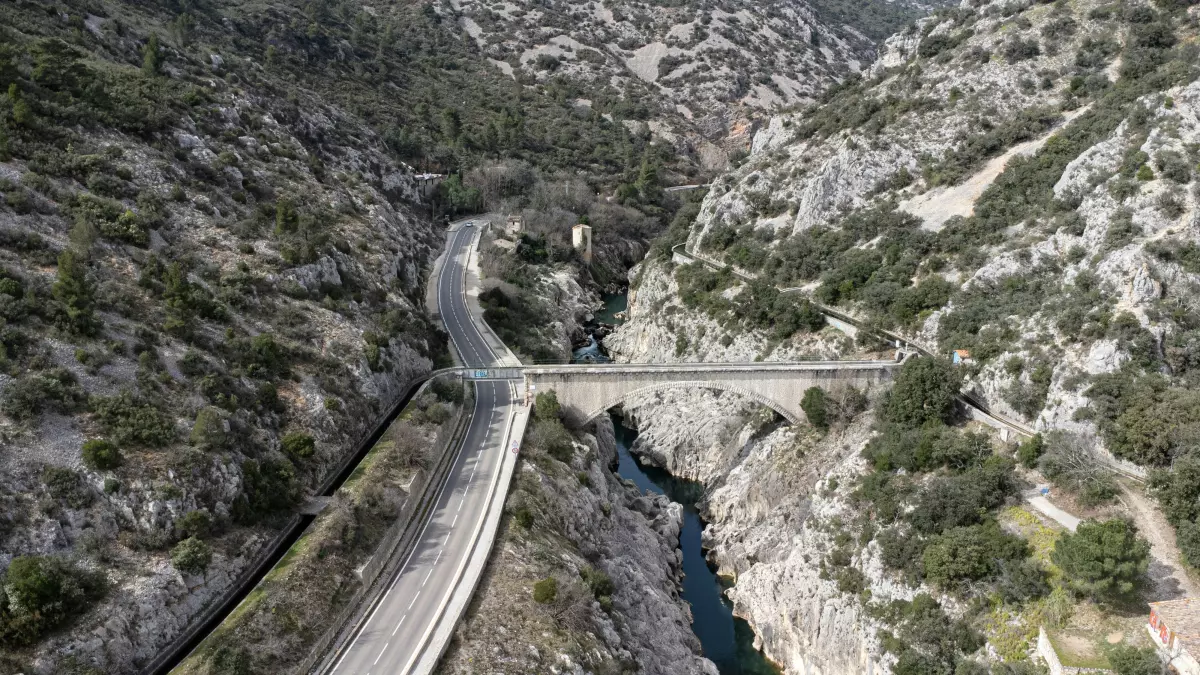 An aerial view of a bridge in a mountainous area.