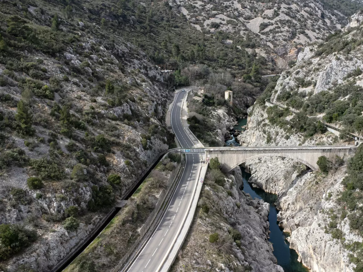 An aerial view of a bridge in a mountainous area.