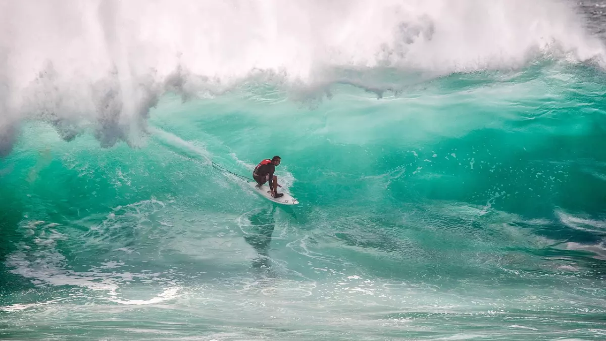 A surfer riding a large wave