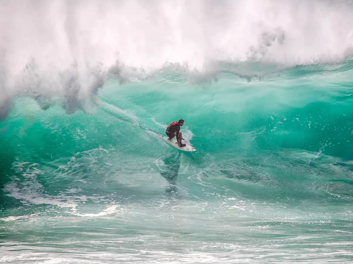 A surfer riding a large wave