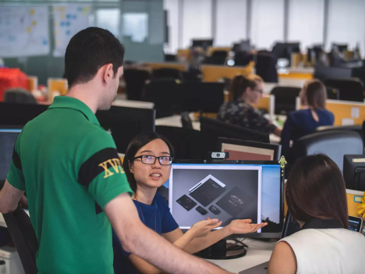 A group of people working on software development in an office.