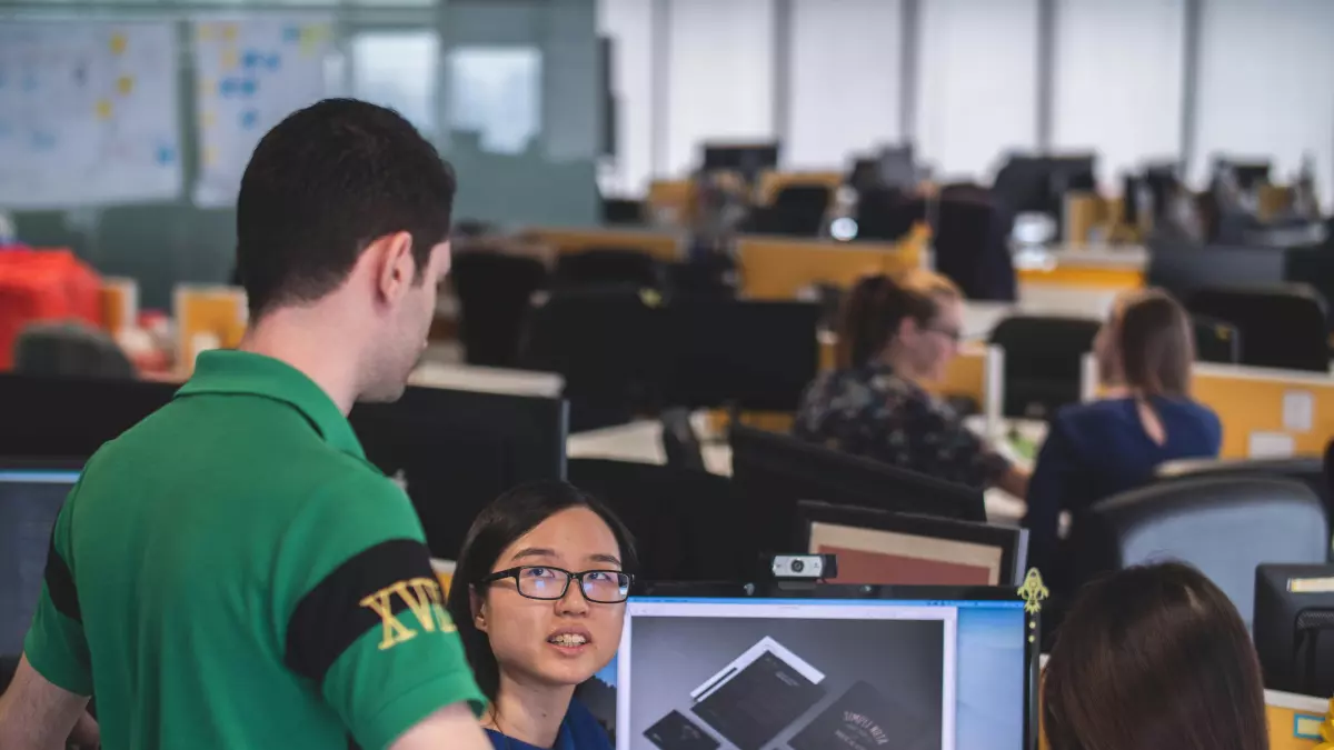 A group of people working on software development in an office.