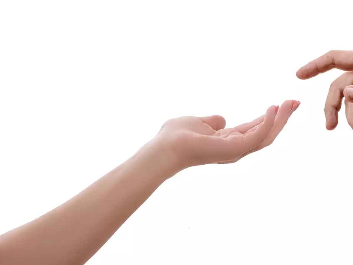 Two hands reaching towards each other on a white background. The left hand is female and the right hand is male. They are positioned as if they are about to touch.