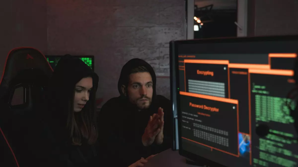 Two hackers in hoodies are working on a computer in a dimly lit room. The image is full of code, with a mysterious aura surrounding them. 