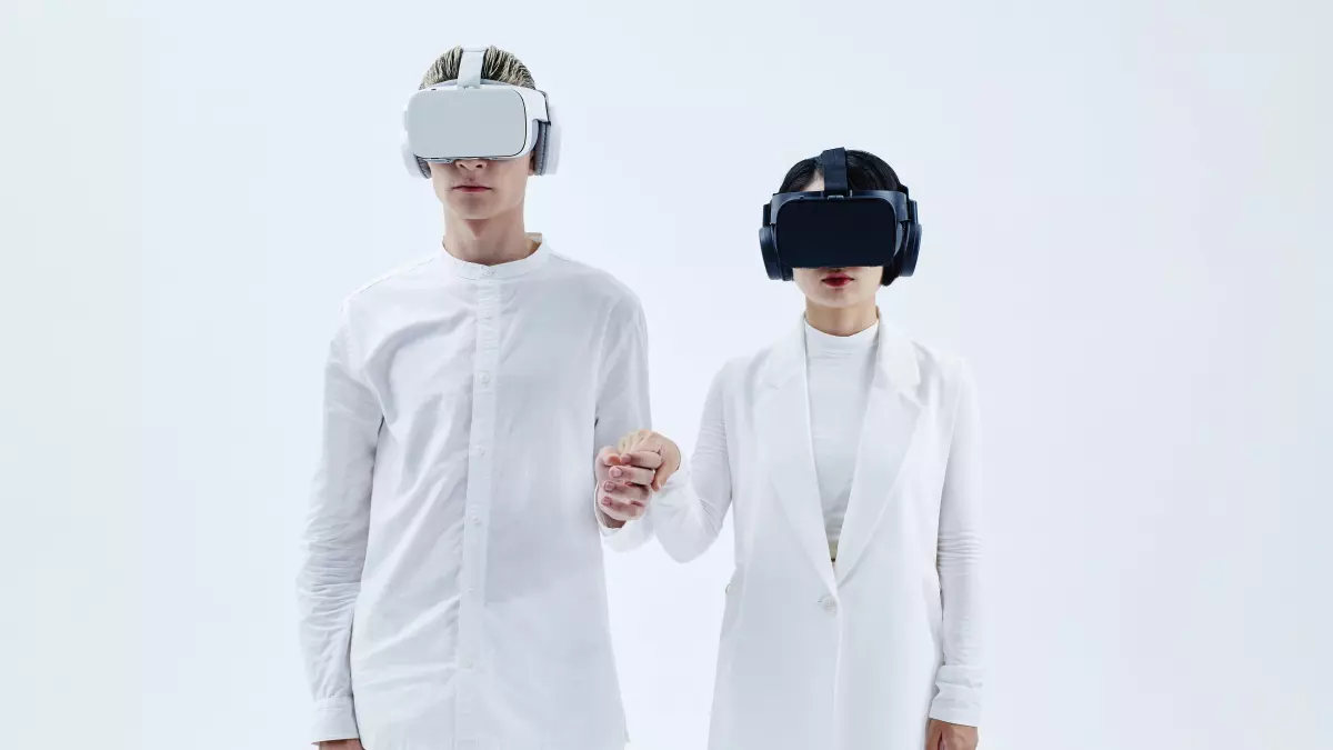 Two people wearing VR headsets standing side by side, representing the fusion of the human and the digital.