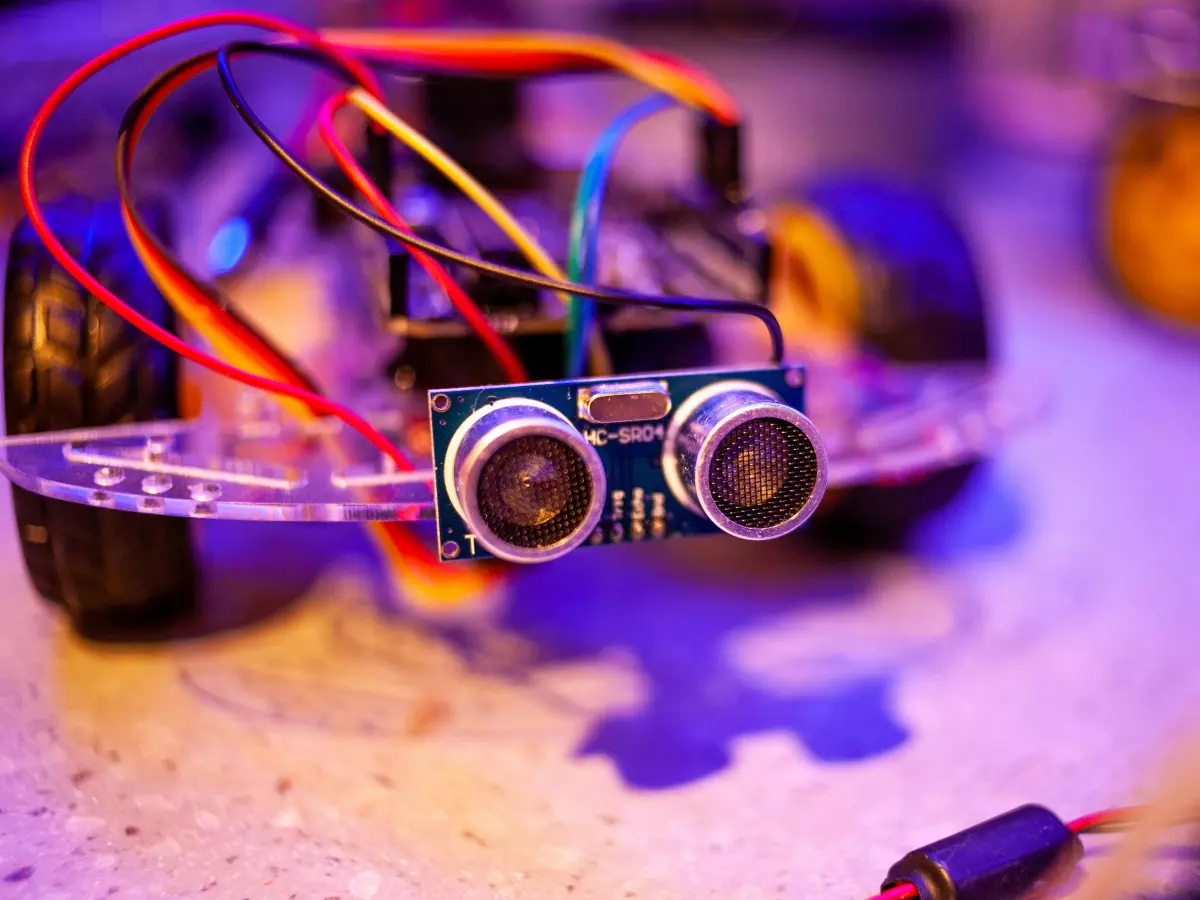 A close-up image of sensors on a robot, with wires and other electronic components visible.