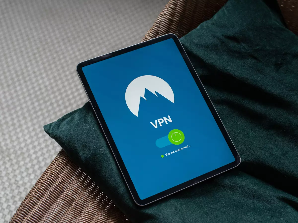 A tablet computer with a VPN app open and the VPN is on. The tablet is laying on a green pillow.