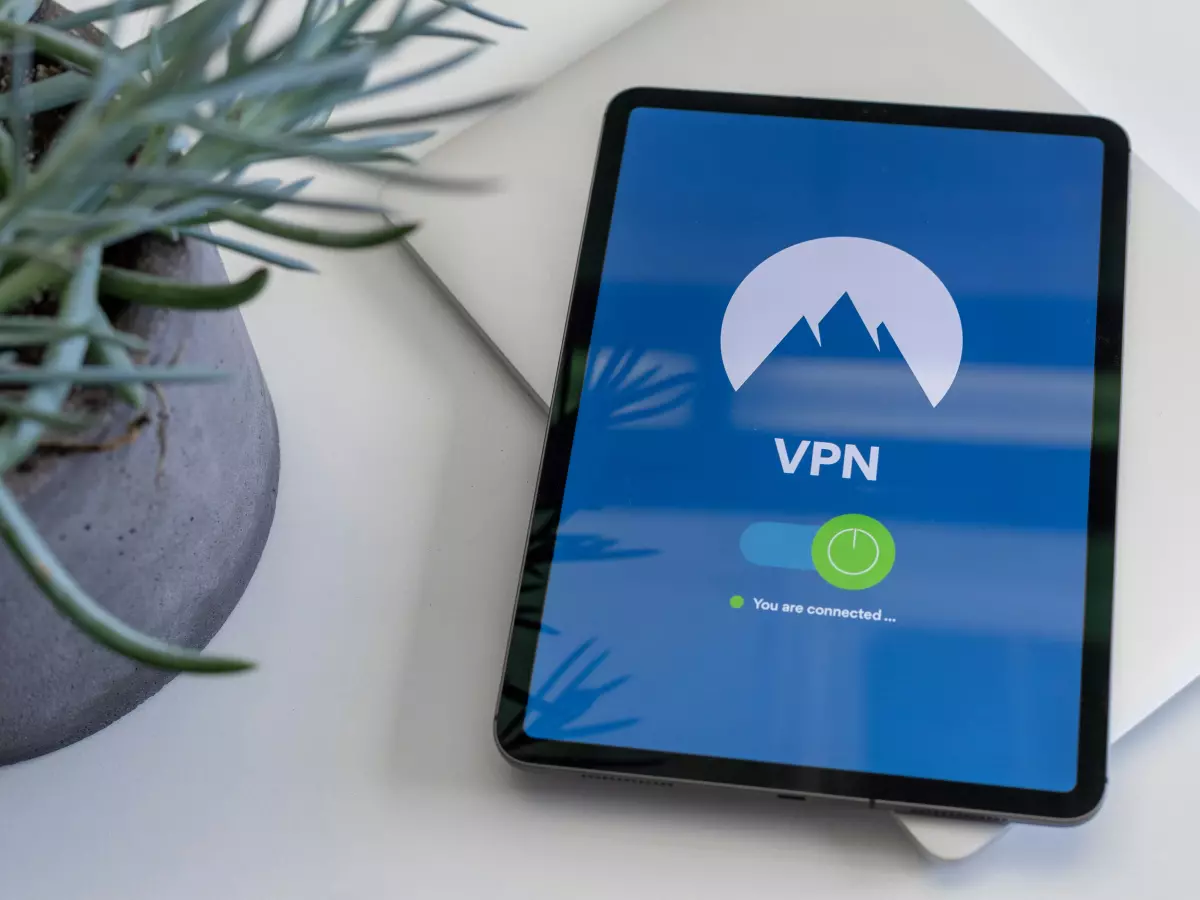 A tablet computer with a VPN connection, a blue background, and a mountain logo.