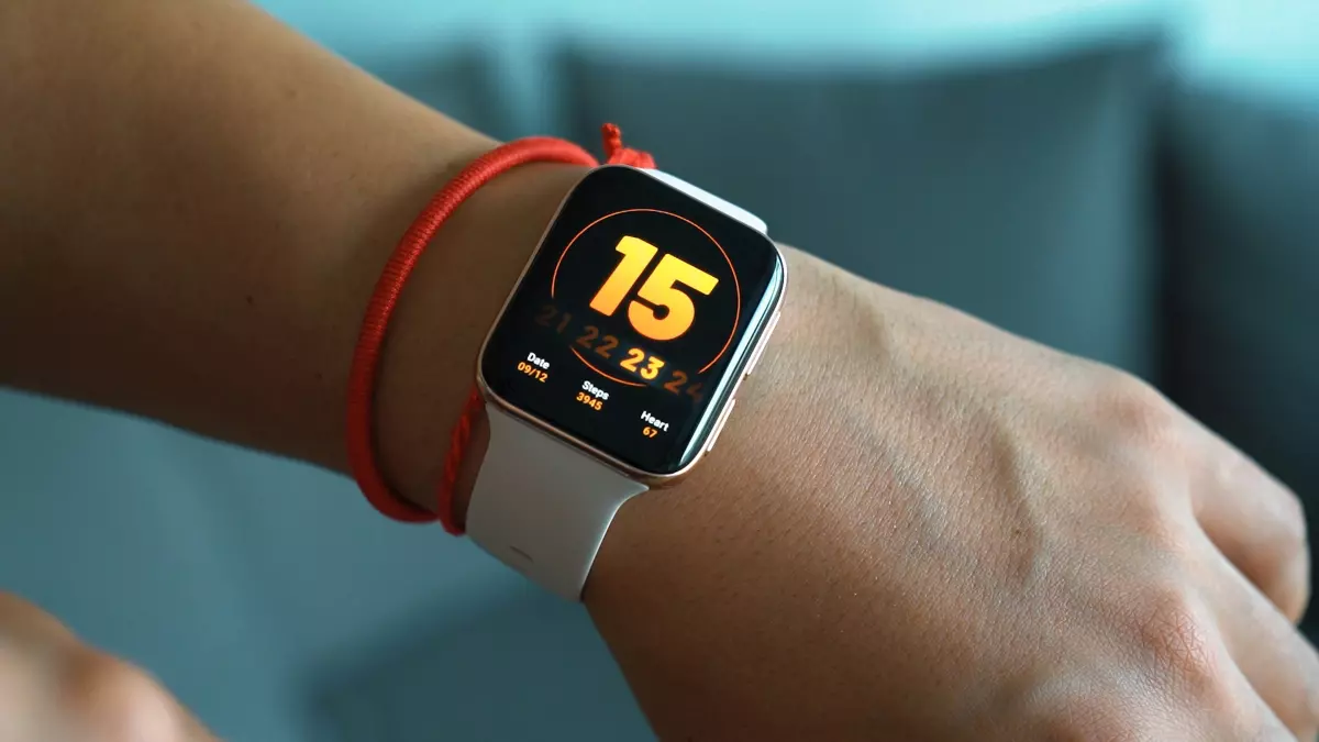 A person wearing a white smartwatch on their left wrist.