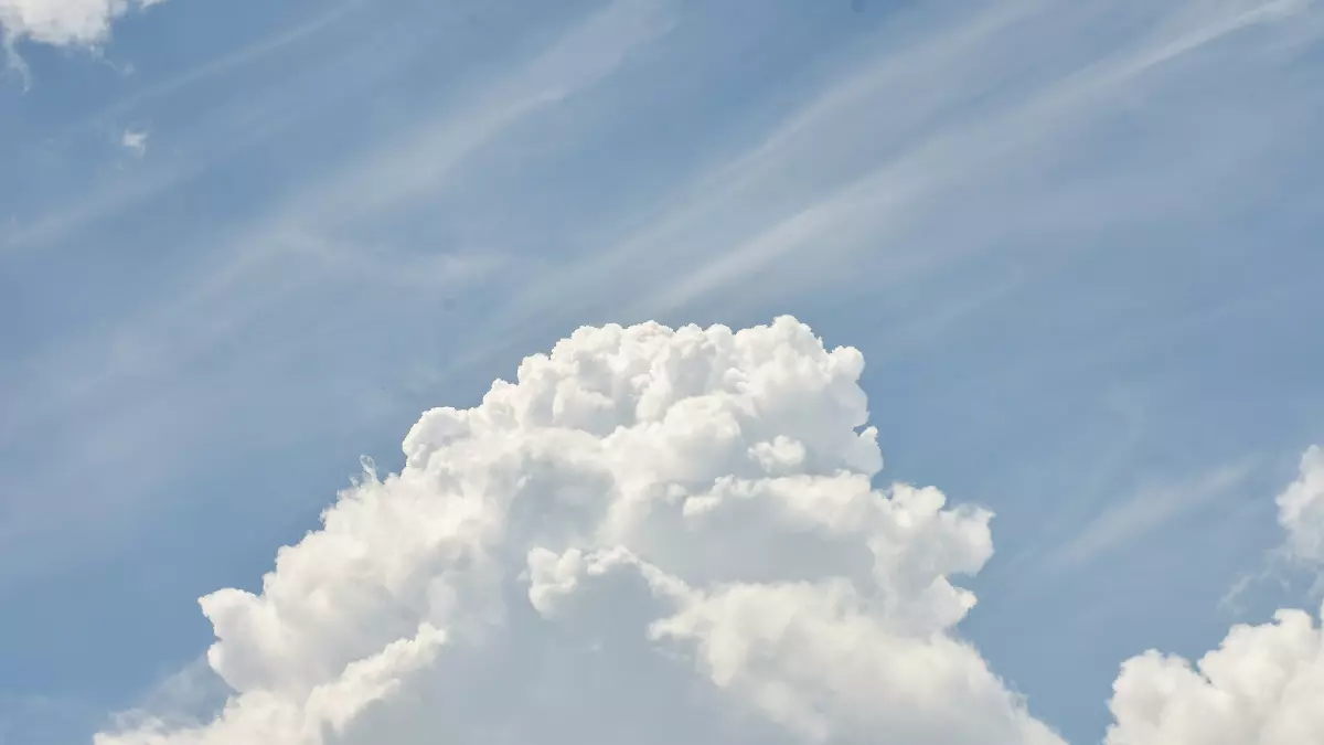 A large, white cloud against a blue sky.