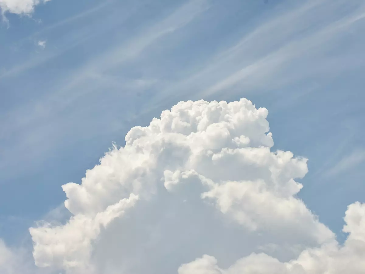 A large, white cloud against a blue sky.