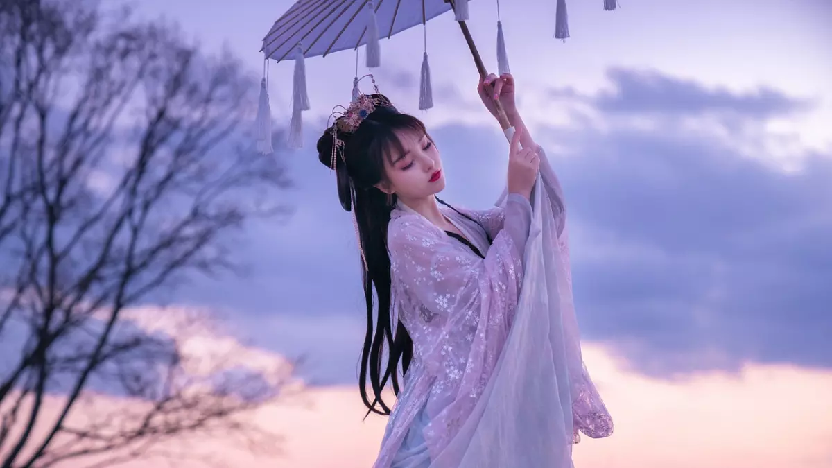 A woman in a traditional Chinese dress with a white parasol stands against a purple sky.