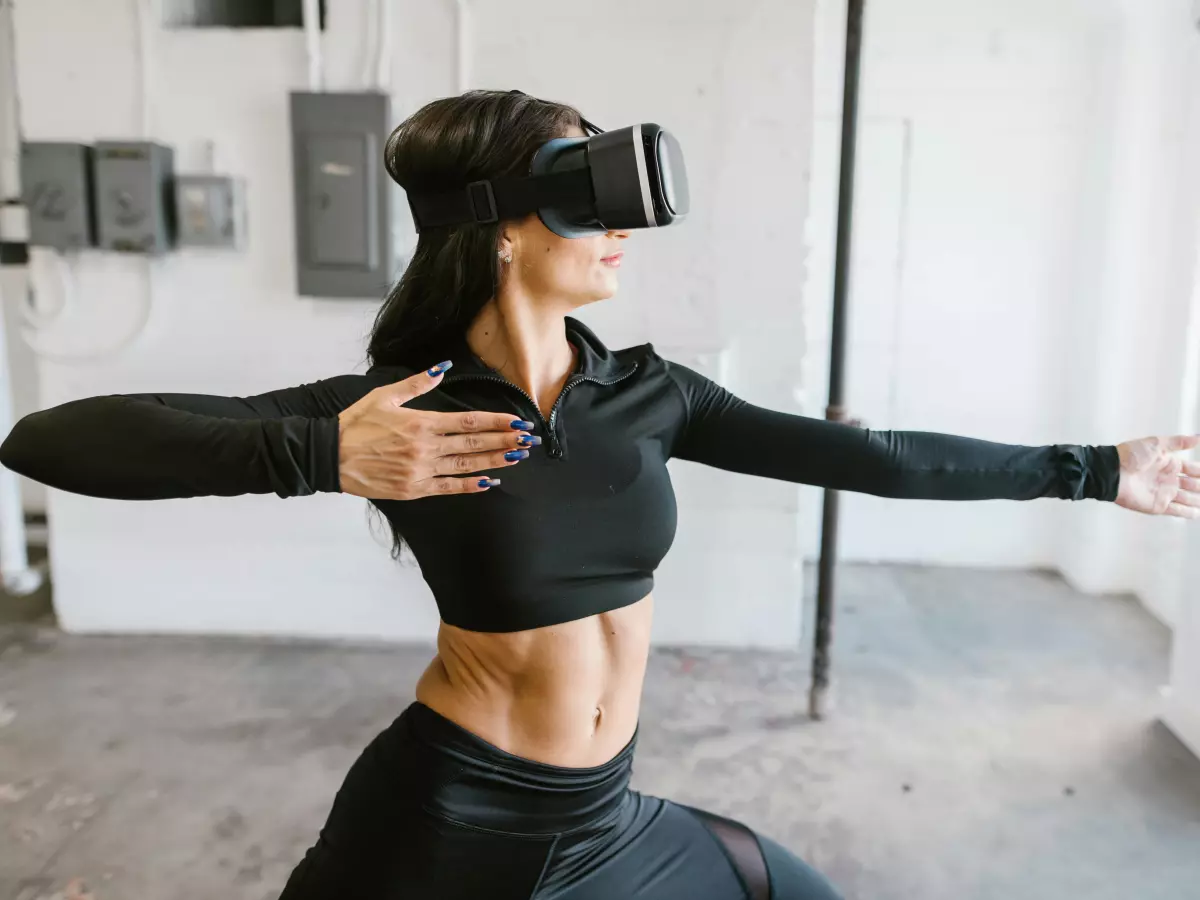 A woman using a VR headset, appearing to participate in a virtual activity.