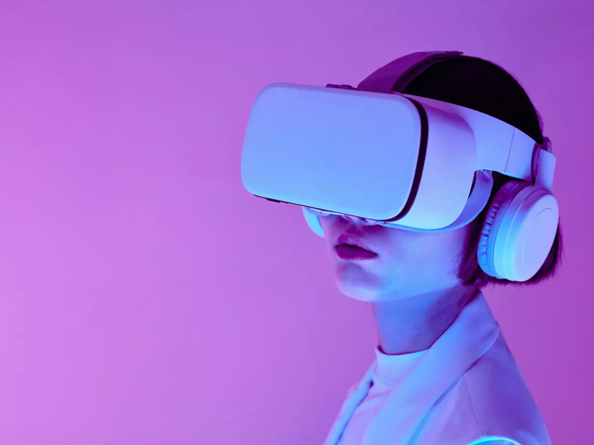 A person wearing a VR headset looks into the distance with a contemplative expression.