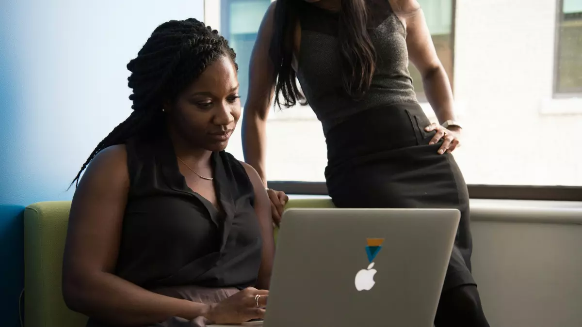 A woman working on a laptop in a casual setting.