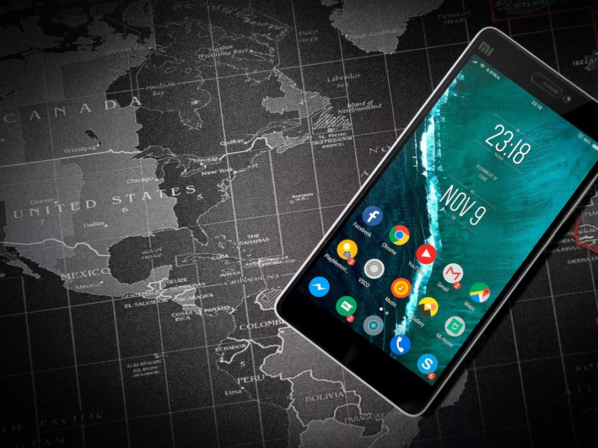 A smartphone with a black bezel and a world map in the background.