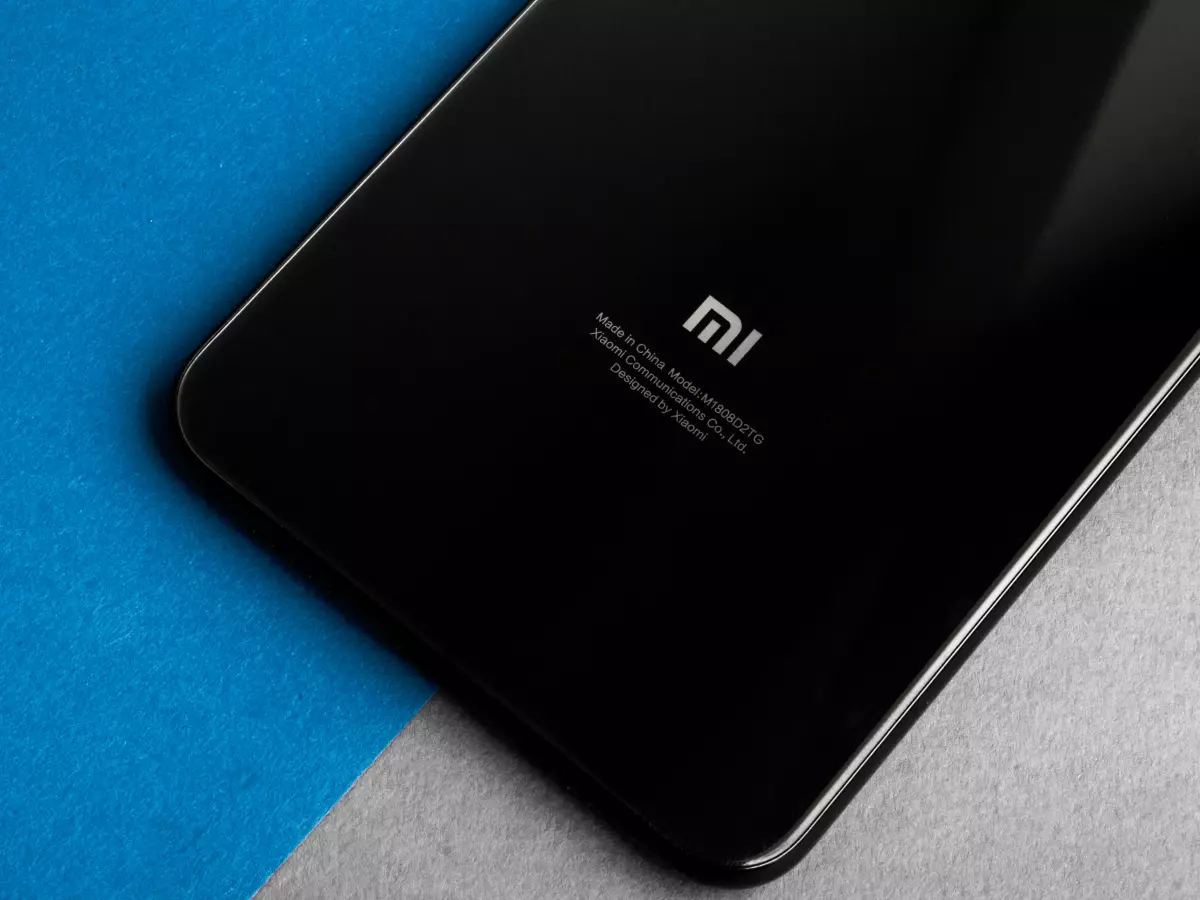 A close-up of the back of a Xiaomi phone, showcasing its black finish and 'Mi' logo.